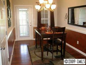 5699 Stafford Road, Unit 72 Charlotte, NC 28215 - Photo 2 of 8 a view of a dining room with furniture and wooden floor