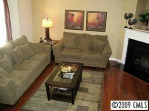 5699 Stafford Road, Unit 72 Charlotte, NC 28215 - Photo 4 of 8 a living room with furniture and a fireplace