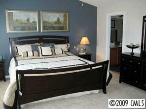 5699 Stafford Road, Unit 72 Charlotte, NC 28215 - Photo 6 of 8 a bed sitting in a bedroom next to a window
