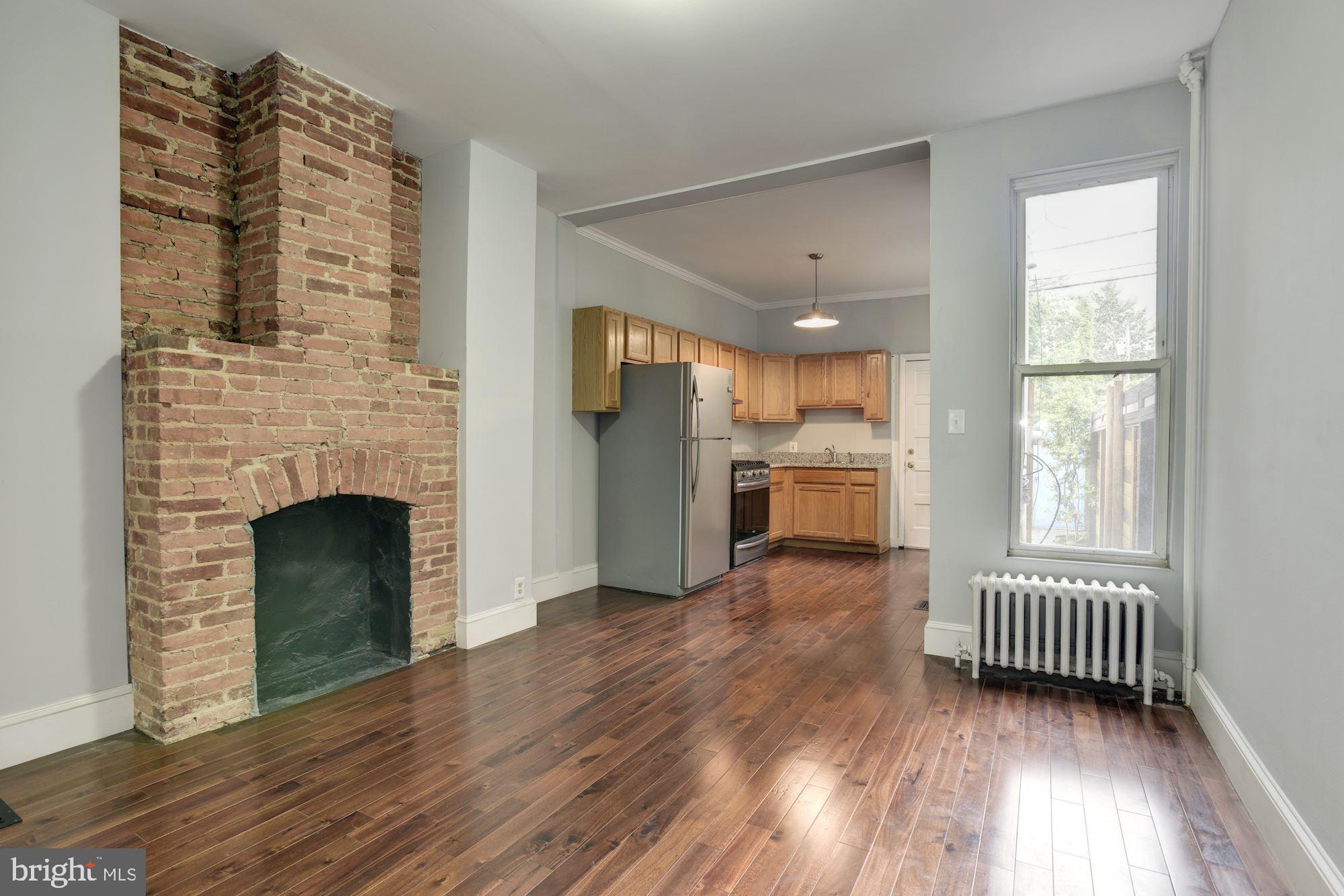 3234 Keswick Road Baltimore, MD 21211 - Photo 12 of 42 Dining Area w/ Exposed Brick Fireplace