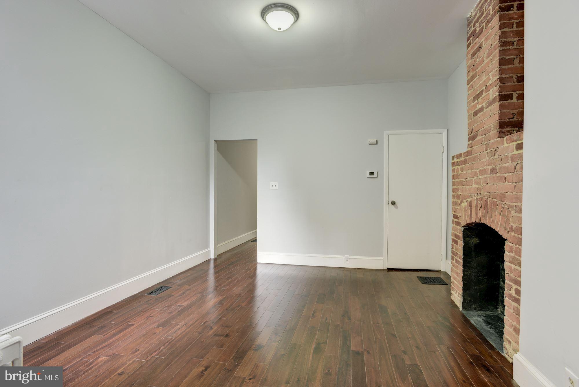 3234 Keswick Road Baltimore, MD 21211 - Photo 14 of 42 Dining Area w/ Exposed Brick Fireplace