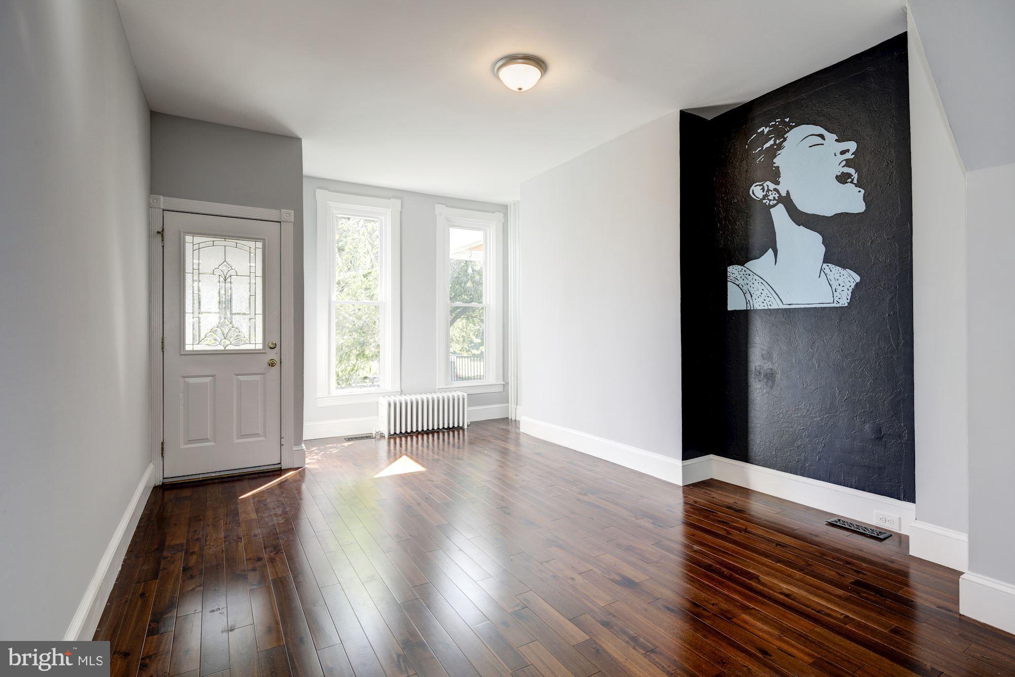 3234 Keswick Road Baltimore, MD 21211 - Photo 6 of 42 Sunlit Living Room w/ Gleaming Hardwood Floors