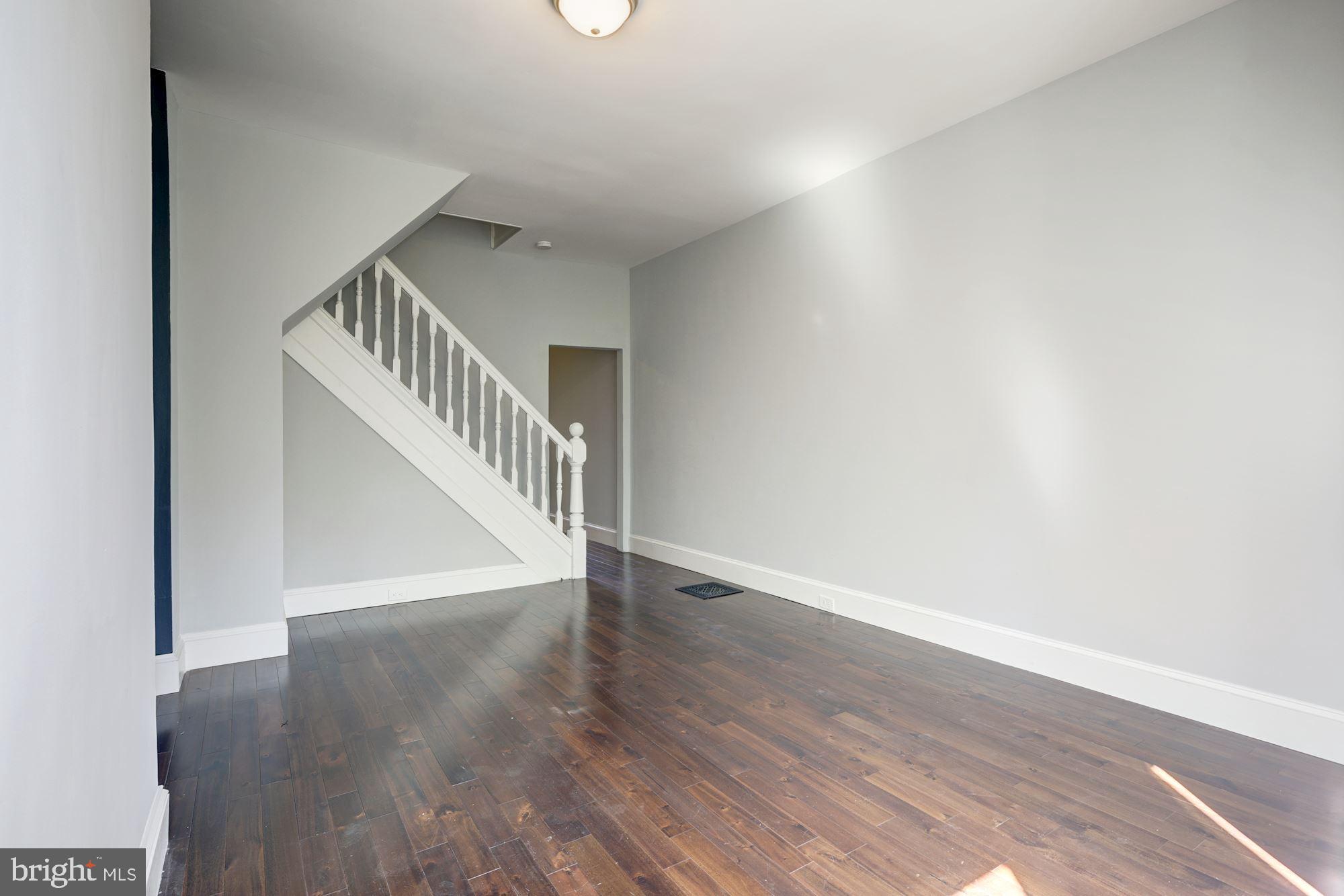 3234 Keswick Road Baltimore, MD 21211 - Photo 10 of 42 Sunlit Living Room w/ Gleaming Hardwood Floors