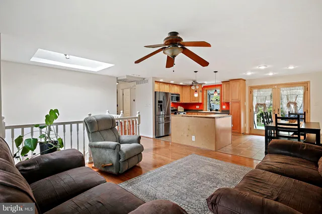 a living room with furniture and kitchen view