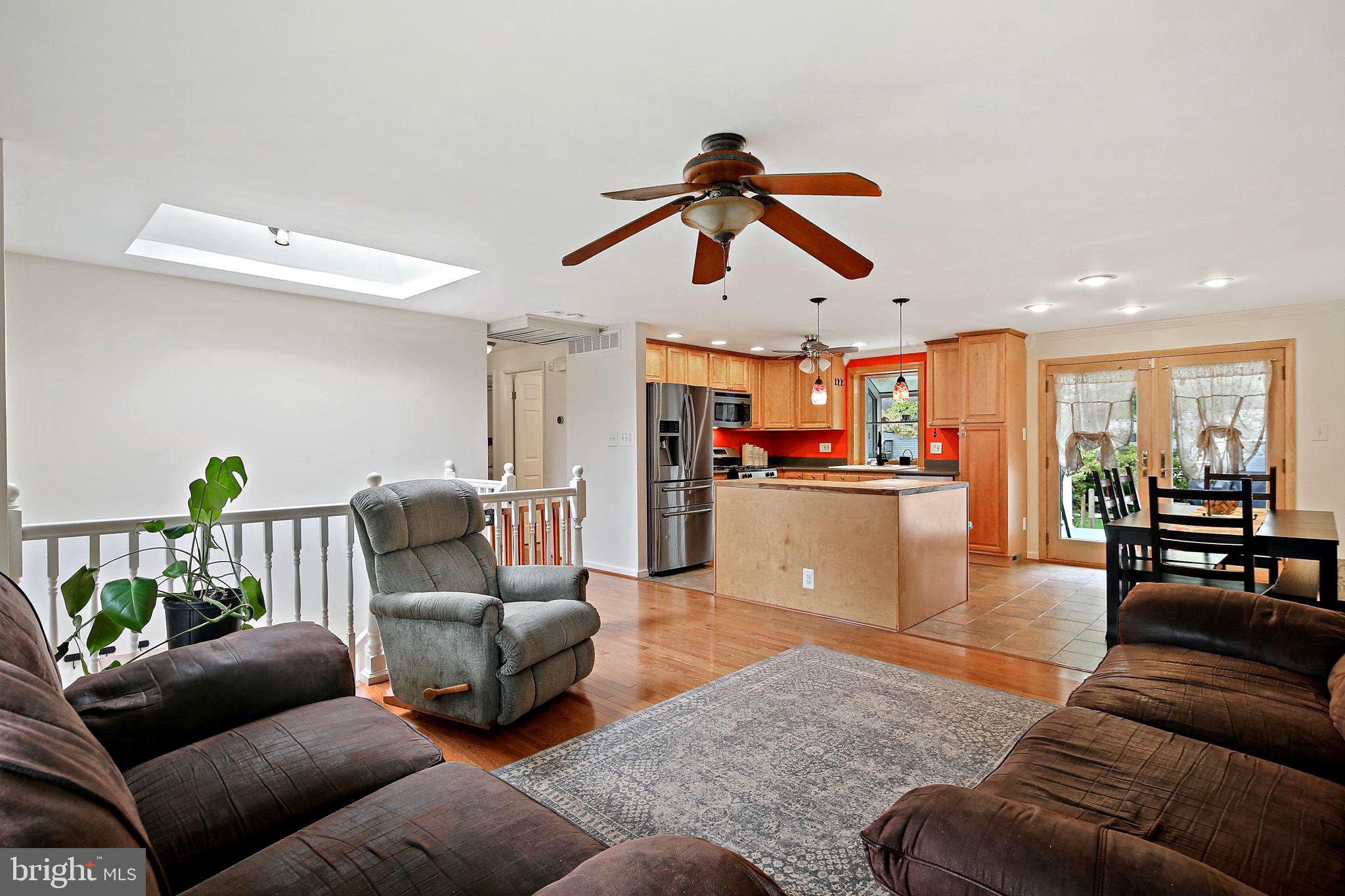 a living room with furniture and kitchen view