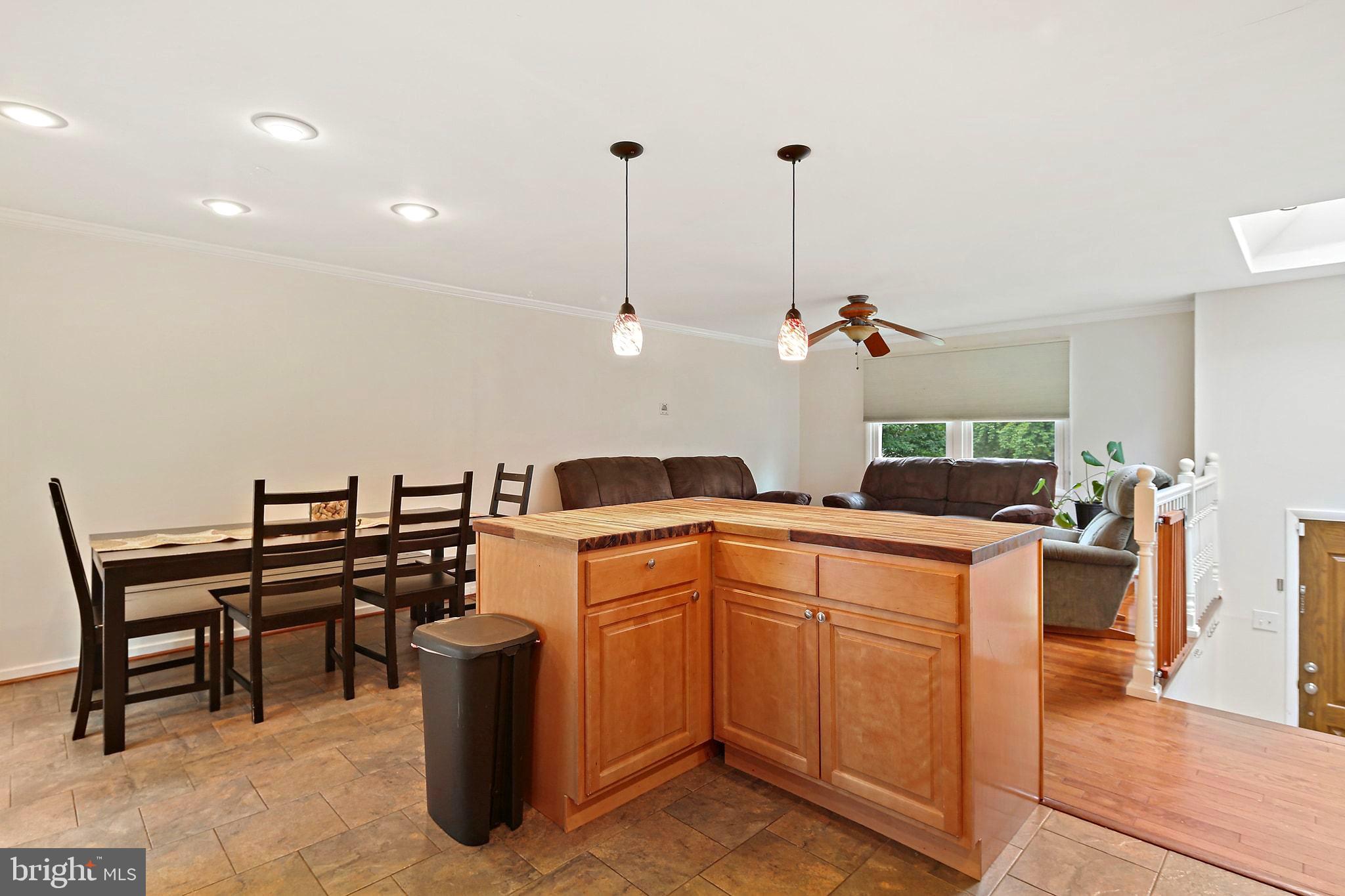 5033 Three Kings Lane Columbia, MD 21044 - Photo 11 of 37 a kitchen with a sink and chairs