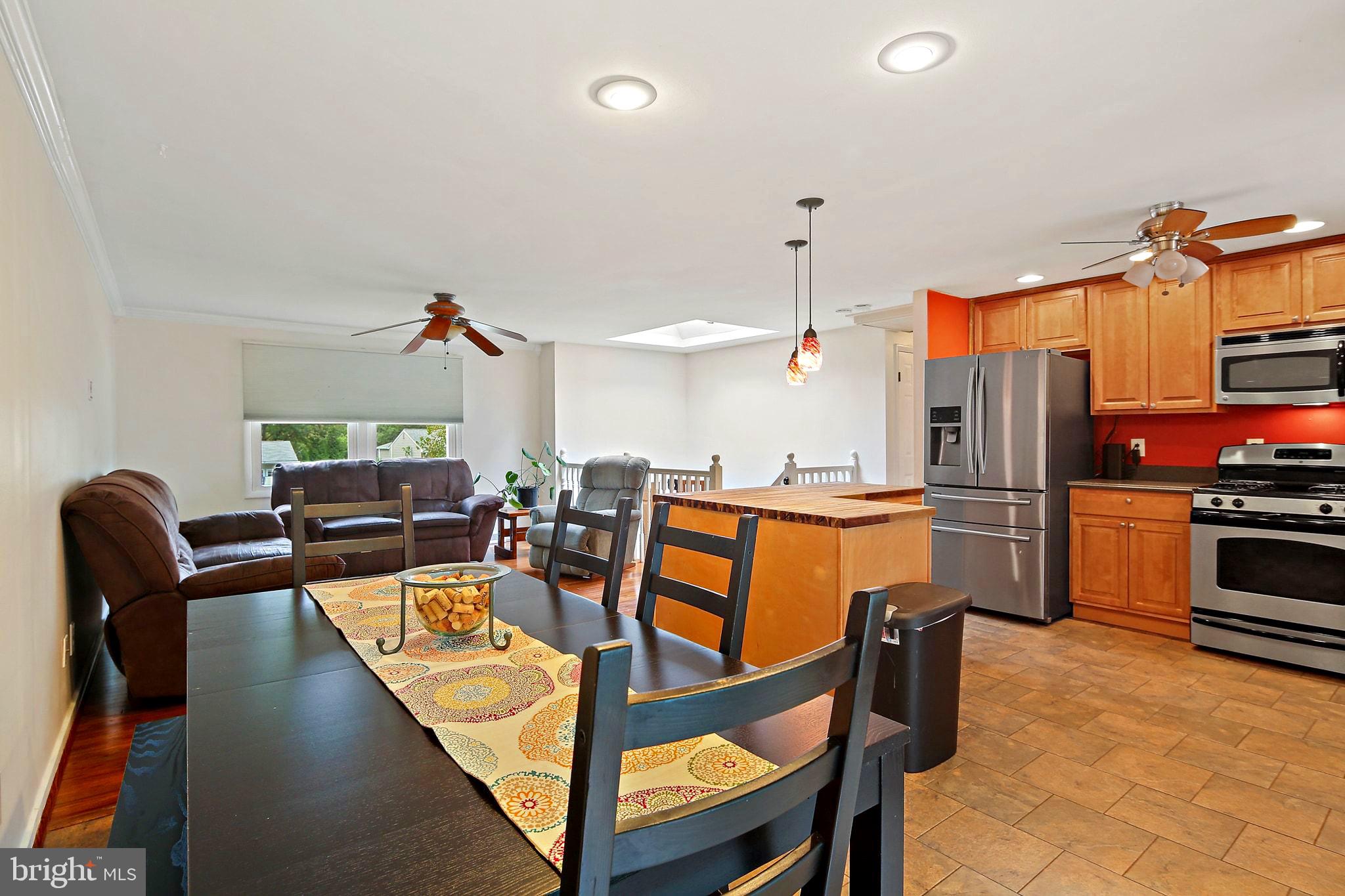 5033 Three Kings Lane Columbia, MD 21044 - Photo 12 of 37 a view of a dining room with furniture and a kitchen