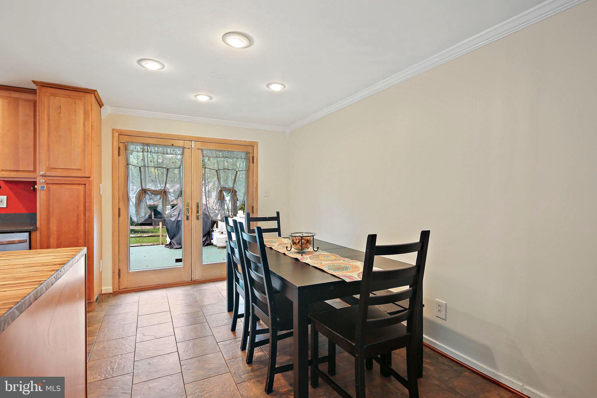 5033 Three Kings Lane Columbia, MD 21044 - Photo 13 of 37 a view of a dining room with furniture and wooden floor