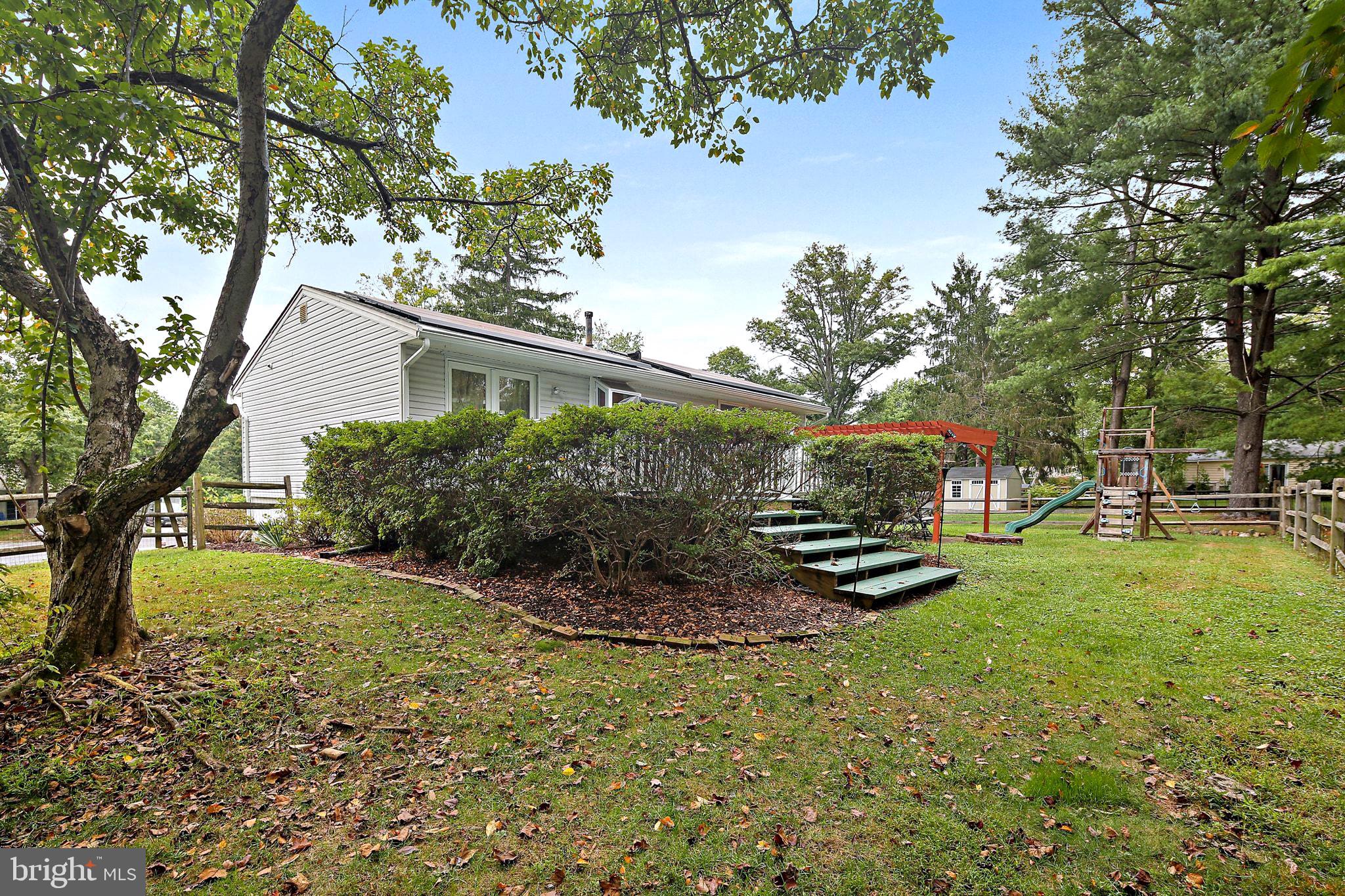 5033 Three Kings Lane Columbia, MD 21044 - Photo 14 of 37 a view of a backyard with plants and a garden