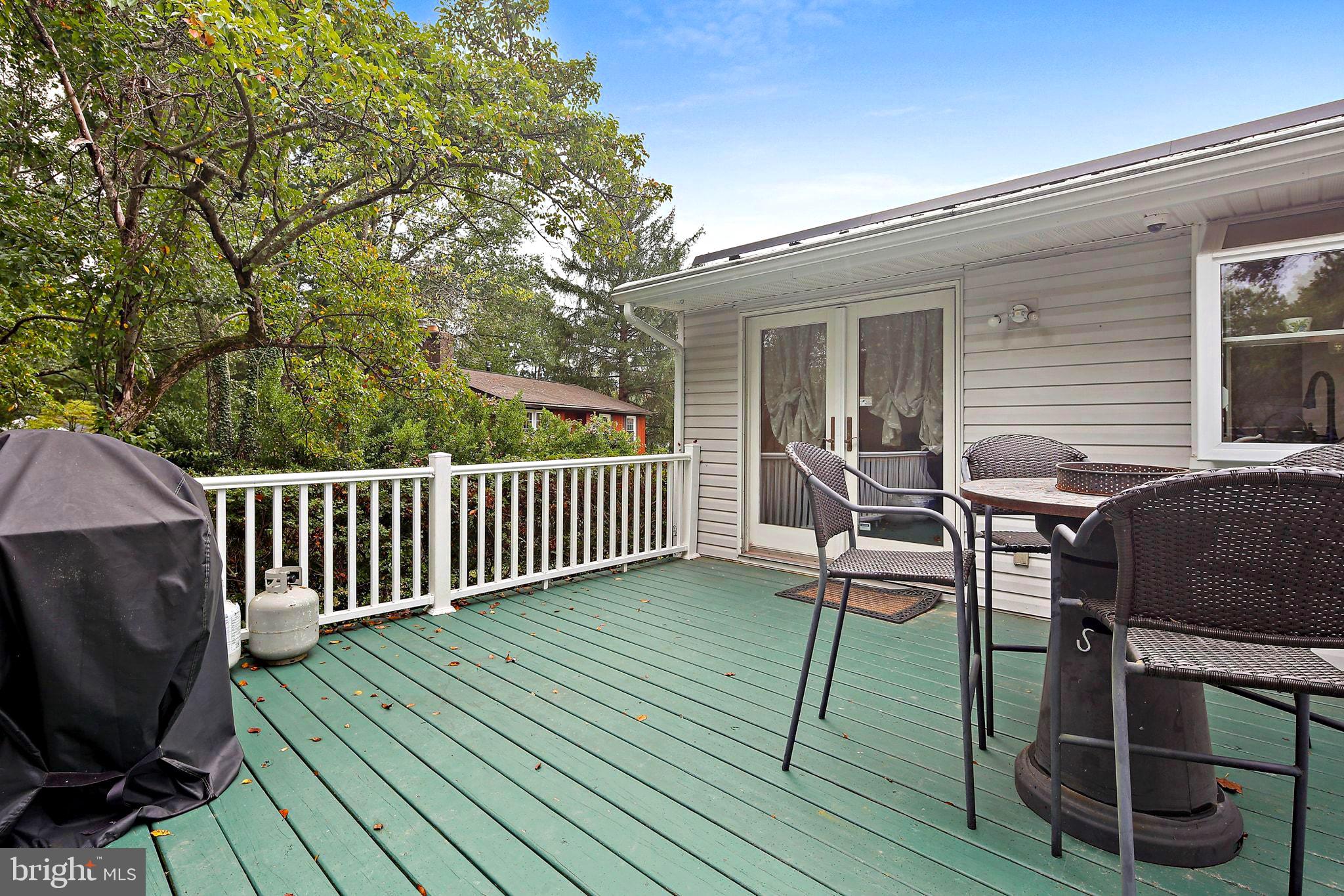 5033 Three Kings Lane Columbia, MD 21044 - Photo 15 of 37 a view of deck with table and chairs and wooden floor