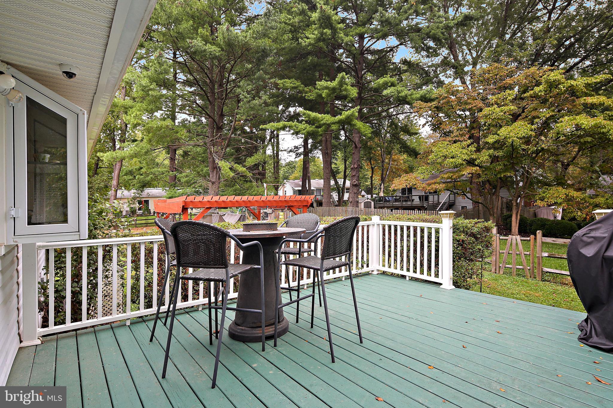 5033 Three Kings Lane Columbia, MD 21044 - Photo 16 of 37 a view of a deck with furniture and trees