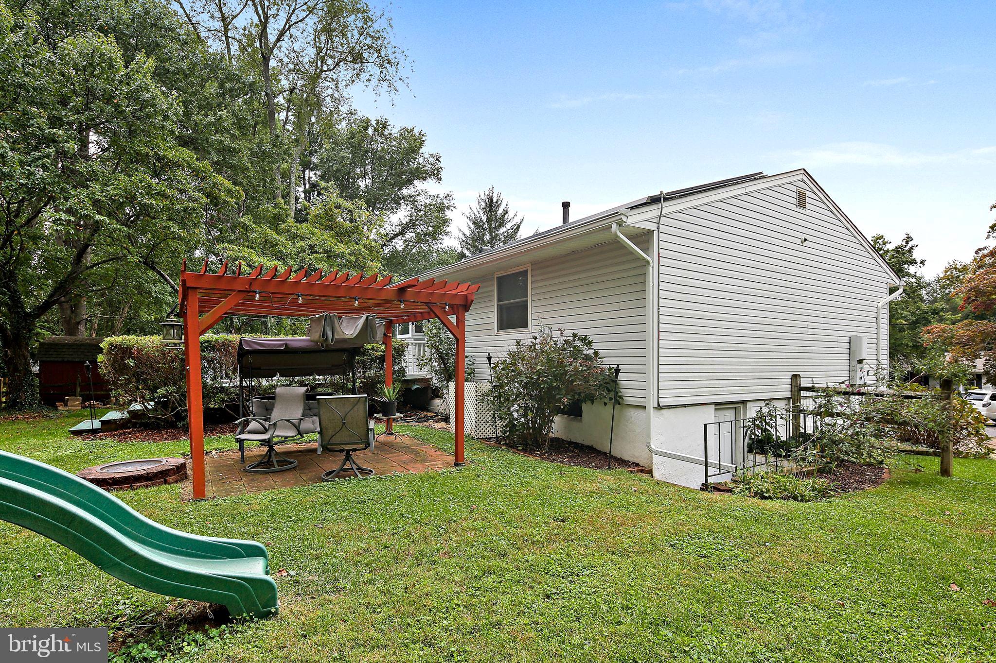 5033 Three Kings Lane Columbia, MD 21044 - Photo 19 of 37 a view of a chair and table in backyard of the house