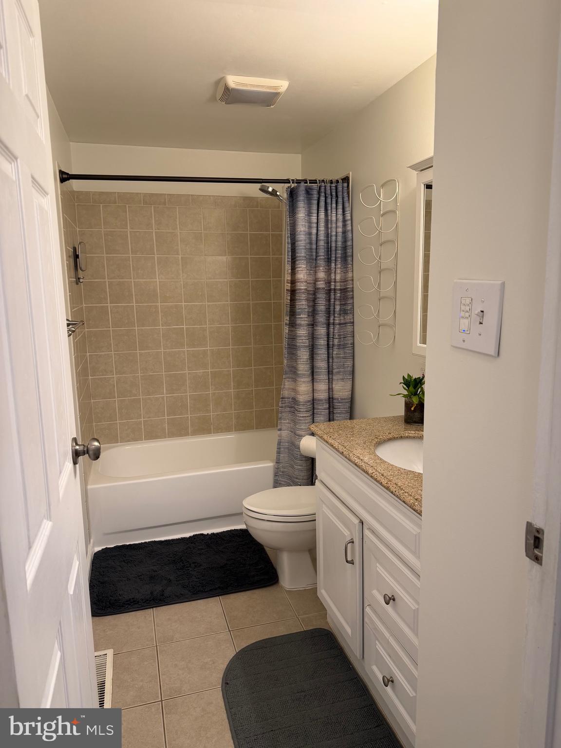 5033 Three Kings Lane Columbia, MD 21044 - Photo 21 of 37 a bathroom with a double vanity sink a toilet a mirror and shower