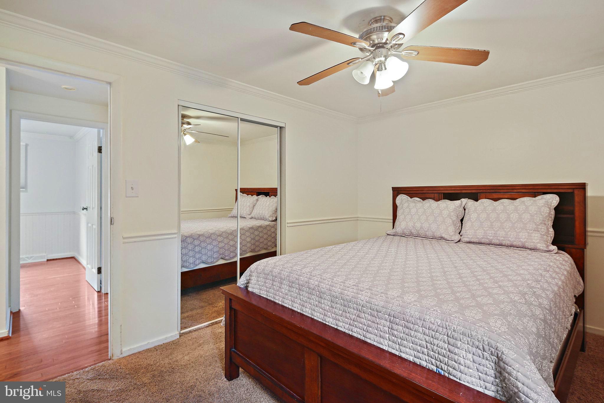 5033 Three Kings Lane Columbia, MD 21044 - Photo 23 of 37 a bedroom with a bed and a chandelier
