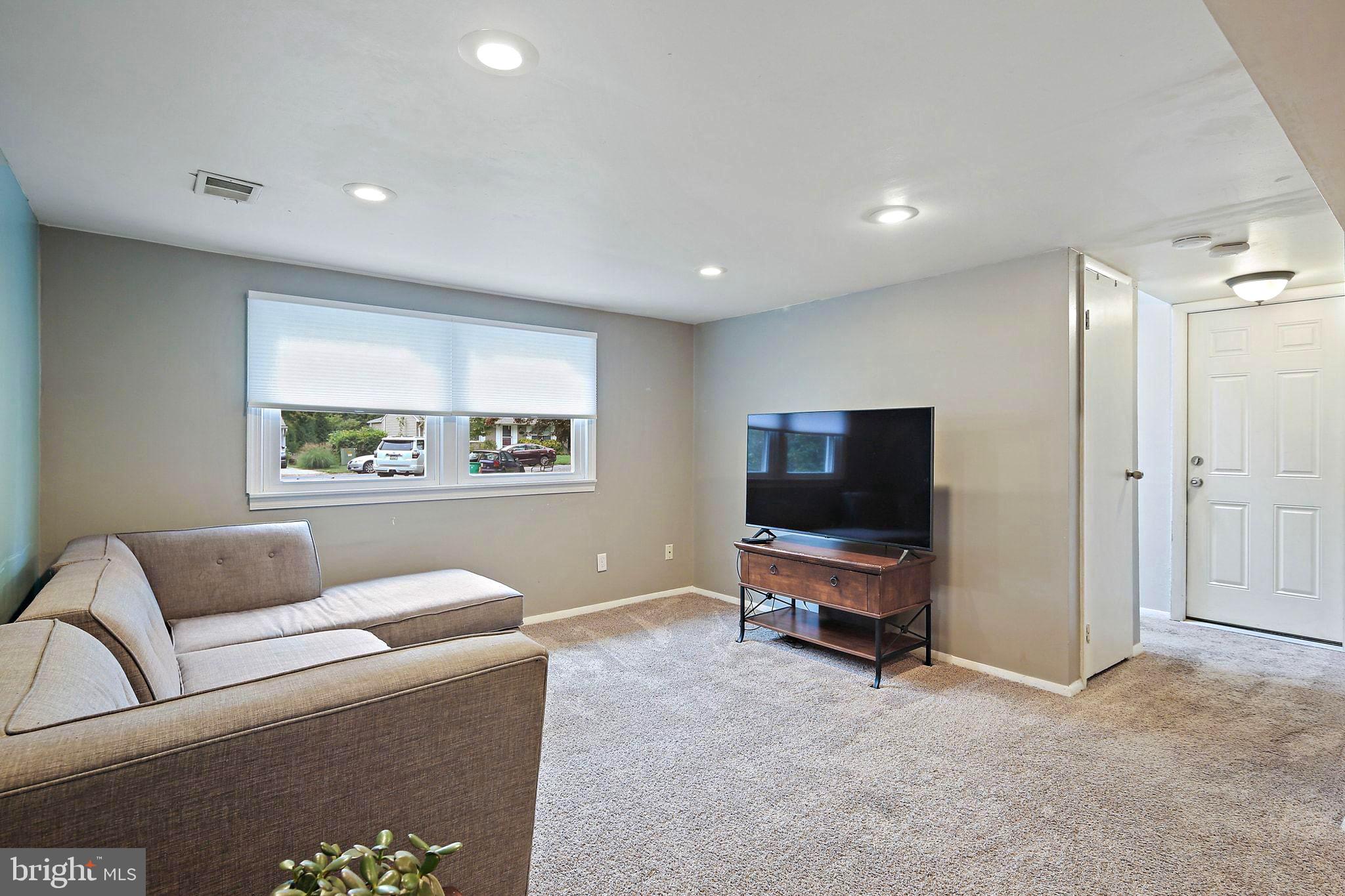 5033 Three Kings Lane Columbia, MD 21044 - Photo 29 of 37 a living room with furniture and a flat screen tv