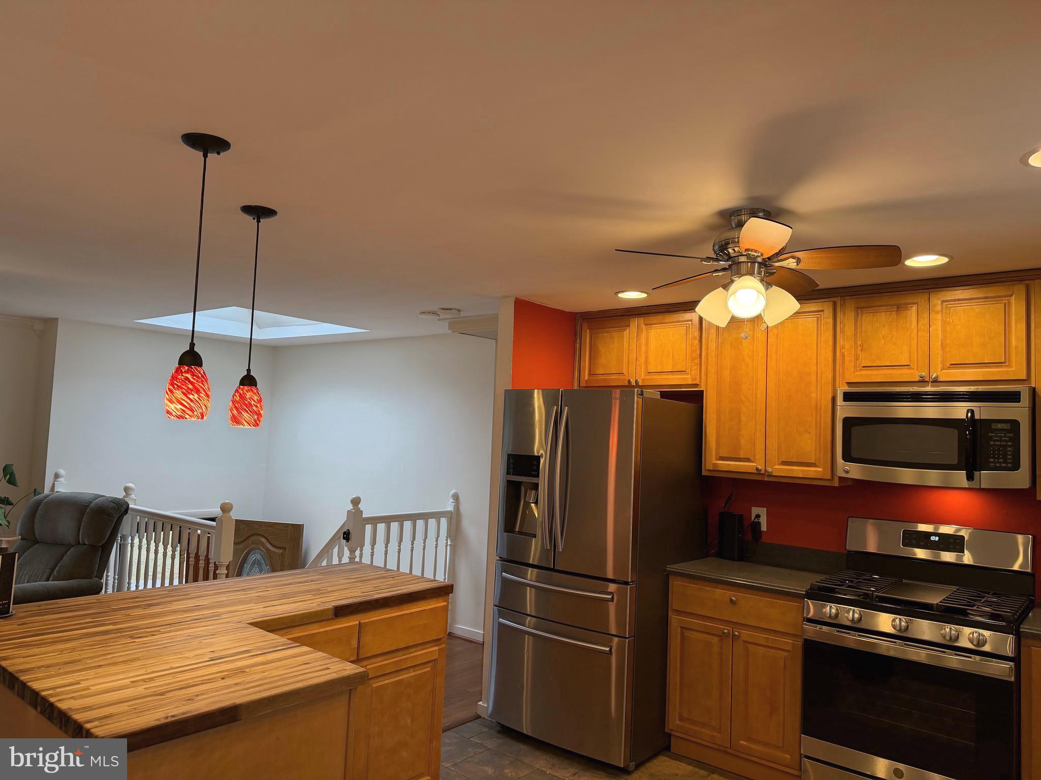 5033 Three Kings Lane Columbia, MD 21044 - Photo 8 of 37 a kitchen with stainless steel appliances granite countertop a refrigerator a stove and a sink