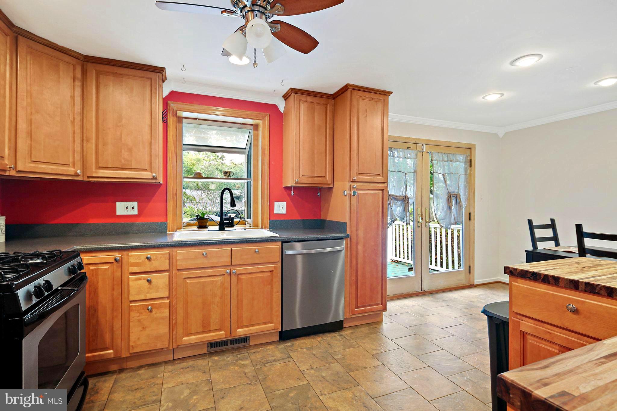 5033 Three Kings Lane Columbia, MD 21044 - Photo 9 of 37 a open kitchen with stainless steel appliances granite countertop a stove a sink and a refrigerator