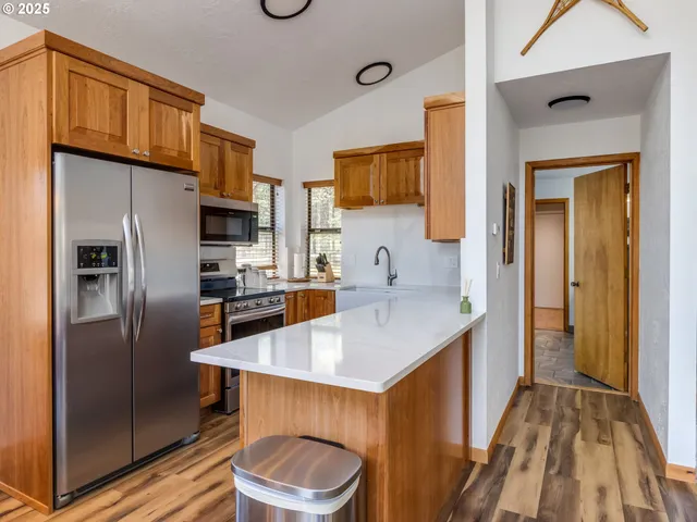 a kitchen with stainless steel appliances a sink stove and cabinets