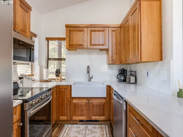 a kitchen with stainless steel appliances a stove sink microwave and cabinets