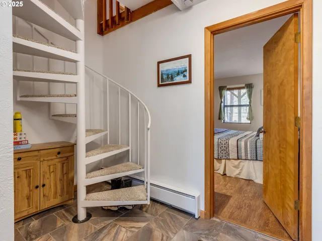 a bed sitting in a spacious bedroom next to a window