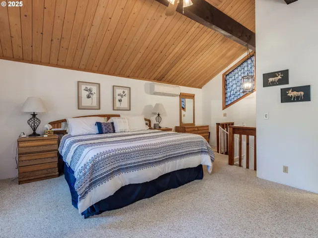 a bedroom with a bed closet and flat tv screen