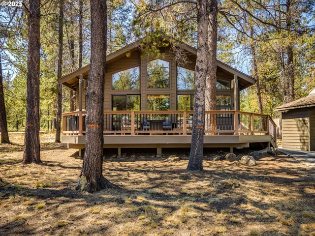 a front view of a house with garden and sitting area