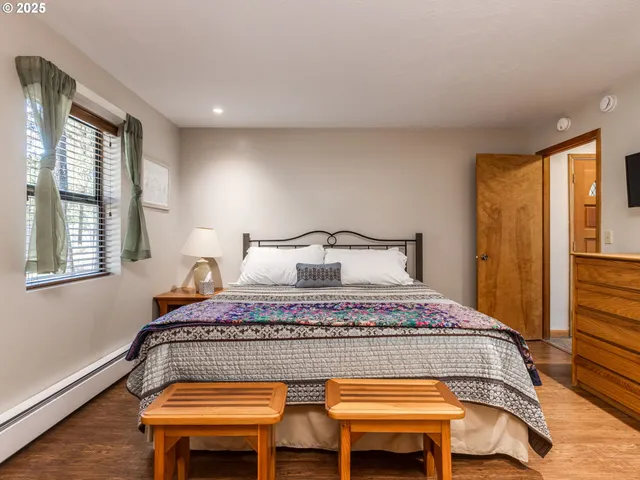 a bedroom with a large bed and a window