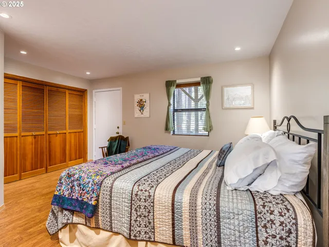 a bedroom with a large bed and a window