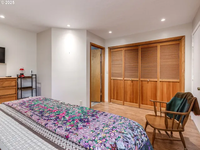 a bedroom with furniture and a flat screen tv