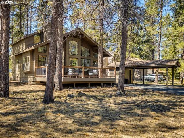 a view of a house with snow on the side of the road