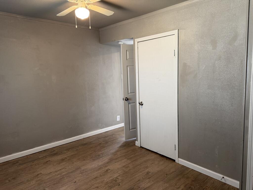 4818 36th Street Lubbock, TX 79414 - Photo 17 of 25 an empty room with wooden floor and fan