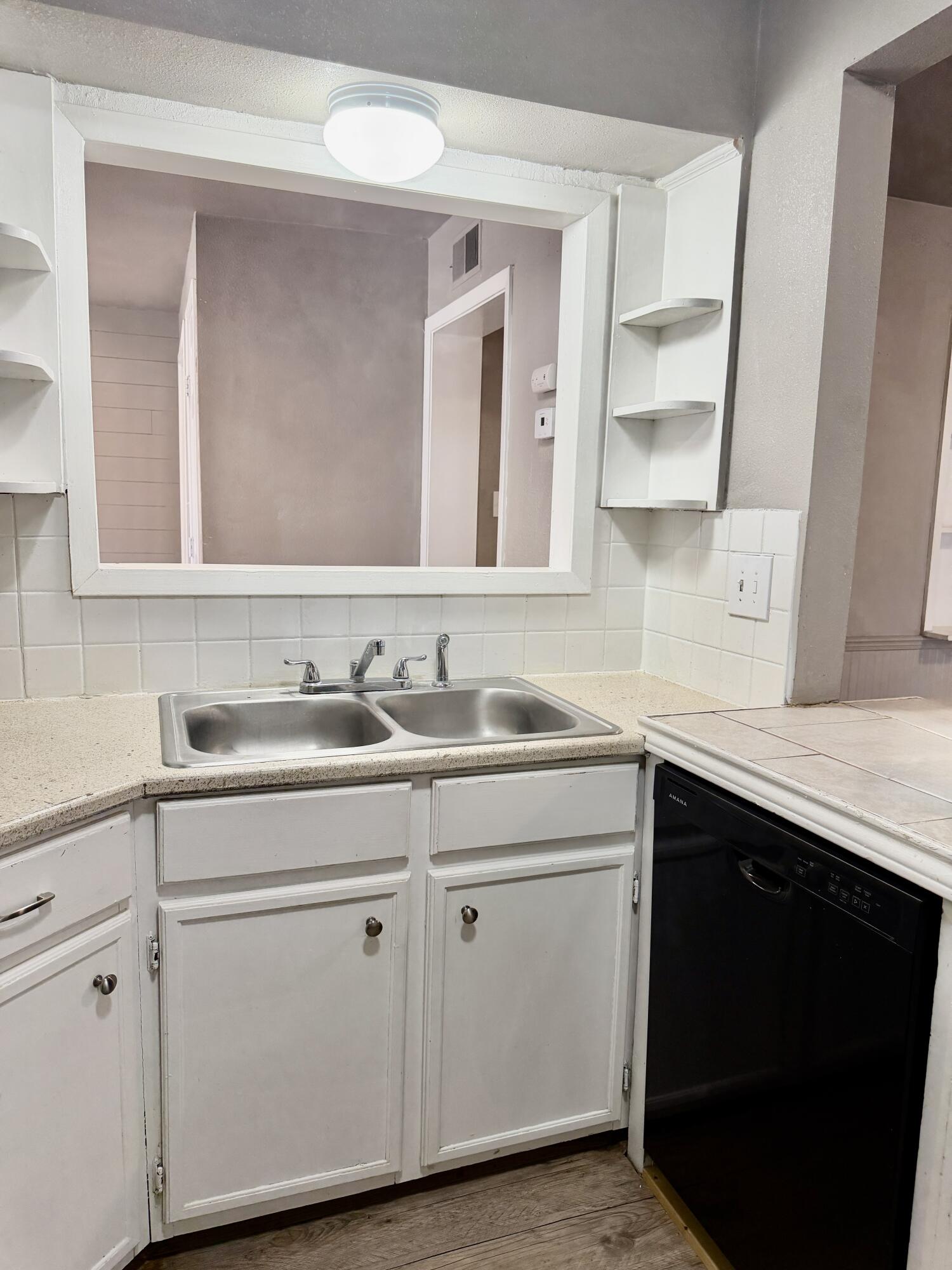 4818 36th Street Lubbock, TX 79414 - Photo 9 of 25 a view with cabinets a sink and dishwasher