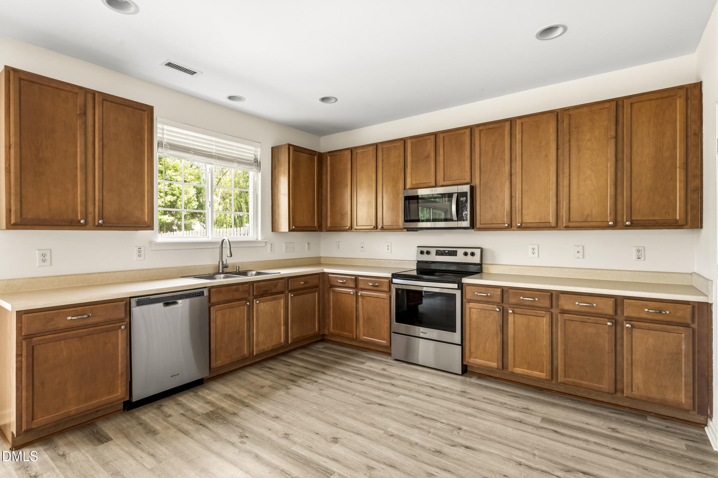112 Ryder Cup Circle Raleigh, NC 27603 - Photo 10 of 45 a kitchen with granite countertop wooden cabinets a sink and appliances