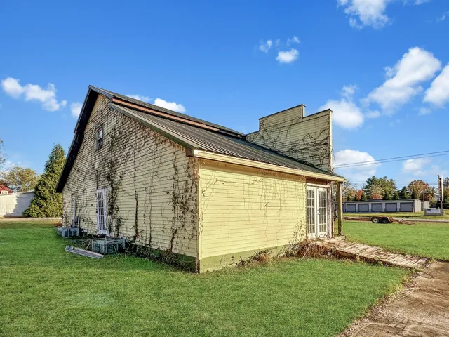 a backyard of a house with table and chairs