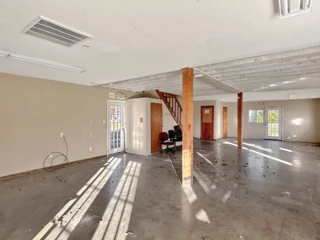 a view of a room with wooden floor and stairs