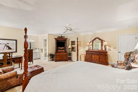 a bedroom with furniture and a fireplace