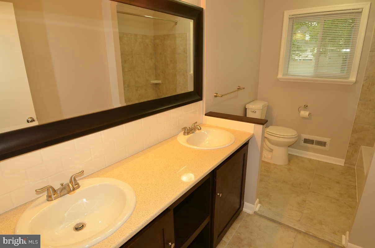6104 Chanceford Road Baltimore, MD 21228 - Photo 13 of 17 a bathroom with a sink and a mirror