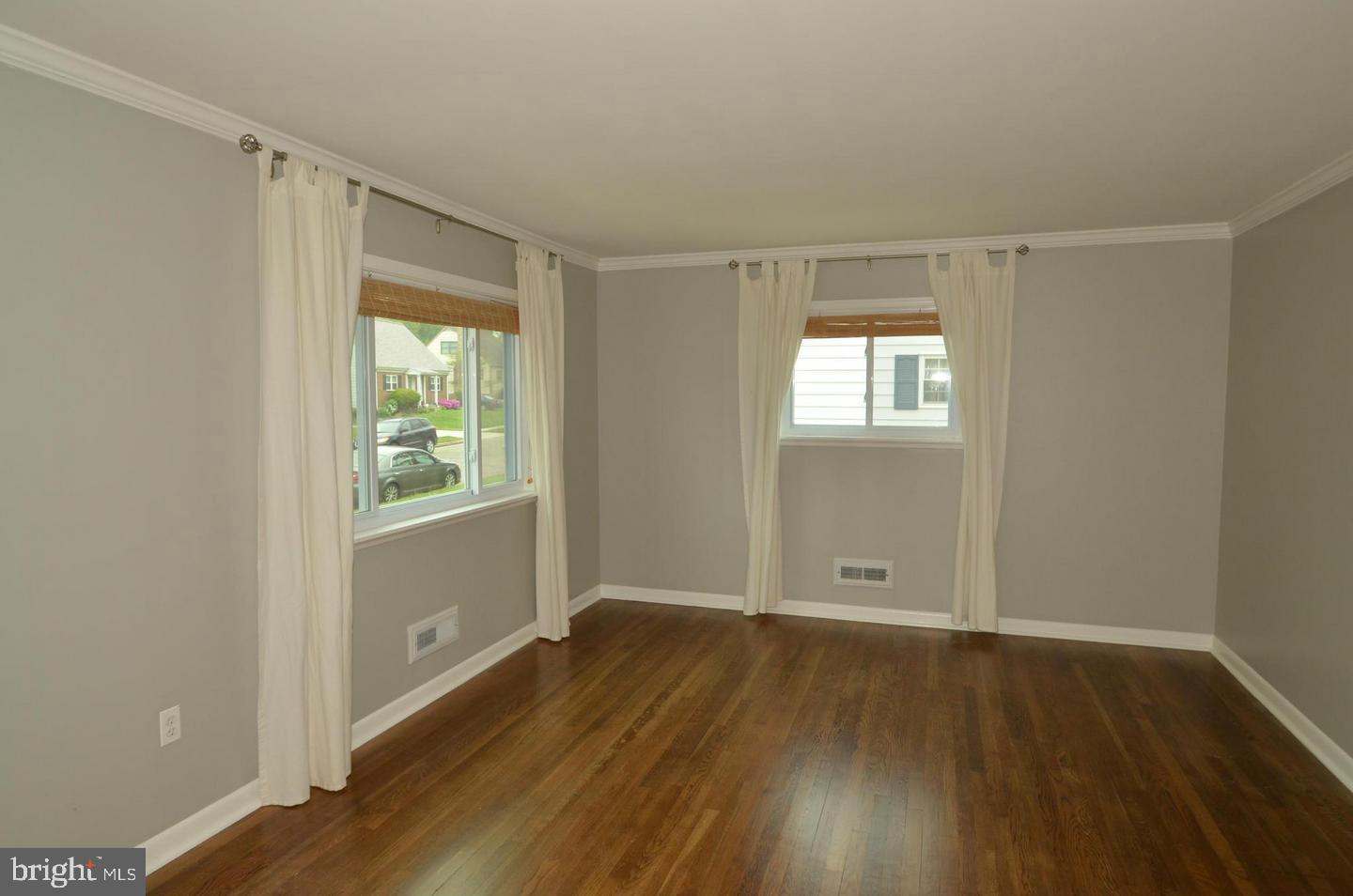 6104 Chanceford Road Baltimore, MD 21228 - Photo 2 of 17 an empty room with wooden floor and windows