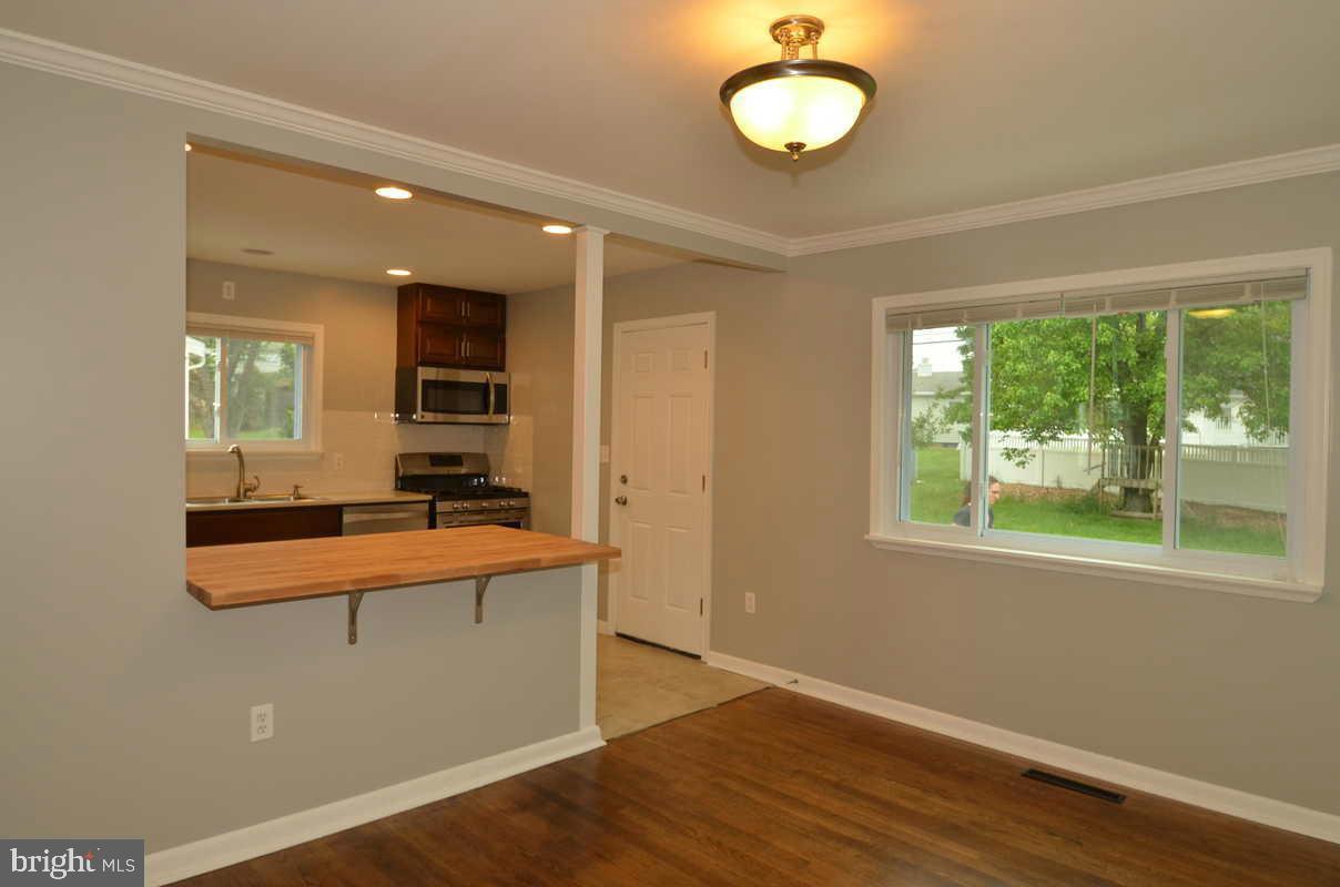 6104 Chanceford Road Baltimore, MD 21228 - Photo 5 of 17 a view of a kitchen with wooden floor and a window