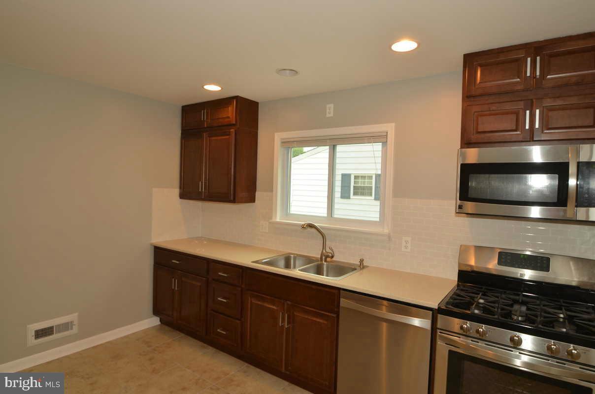 6104 Chanceford Road Baltimore, MD 21228 - Photo 7 of 17 a kitchen with a sink and a stove top oven