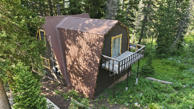 8505 South Snake Crk Road Salt Lake City, UT 84121 - Photo 5 of 67 Wood-sided property featuring a brown metal roof