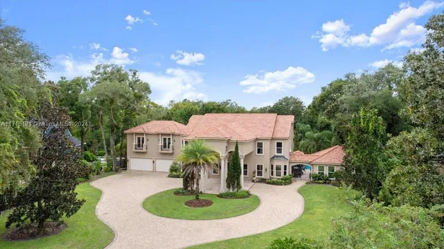 an aerial view of a house with pool yard and outdoor seating