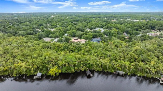 a spacious bathroom with a granite countertop sink a toilet and a mirror