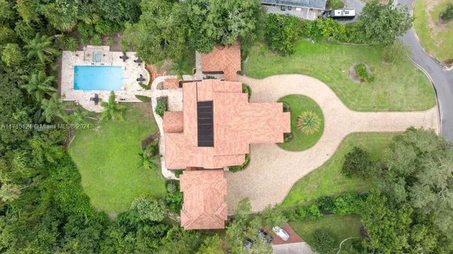 a front view of a house with a garden and yard