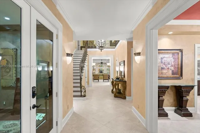 a spacious bedroom with a large bed and a chandelier