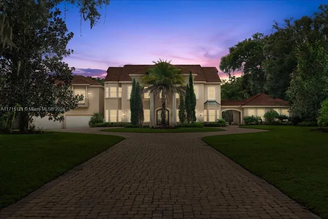 a view of a patio with couches and table and chairs with wooden fence and plants