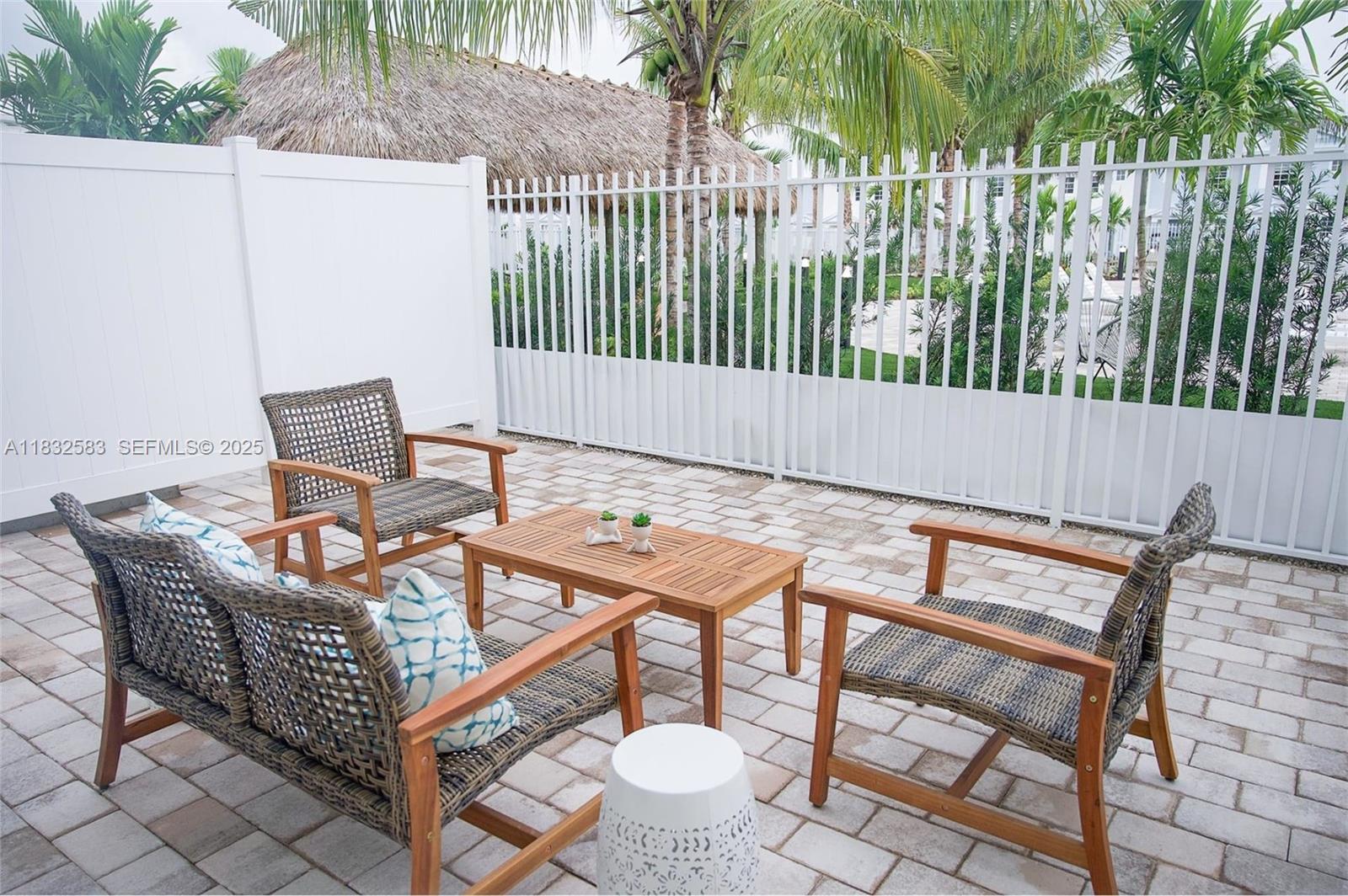 3644 Blue Fin Way, Unit 101 Fort Myers, FL 33916 - Photo 1 of 8 a backyard of a house with table and chairs