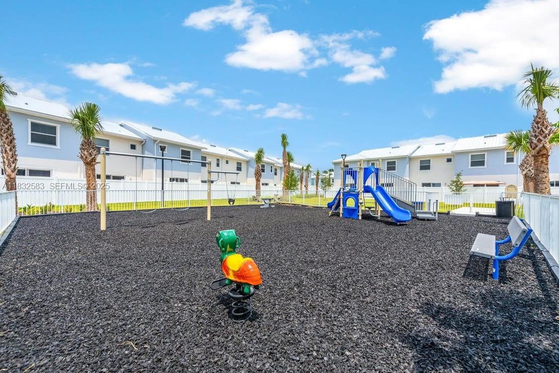 3644 Blue Fin Way, Unit 101 Fort Myers, FL 33916 - Photo 7 of 8 a view of a park with swings