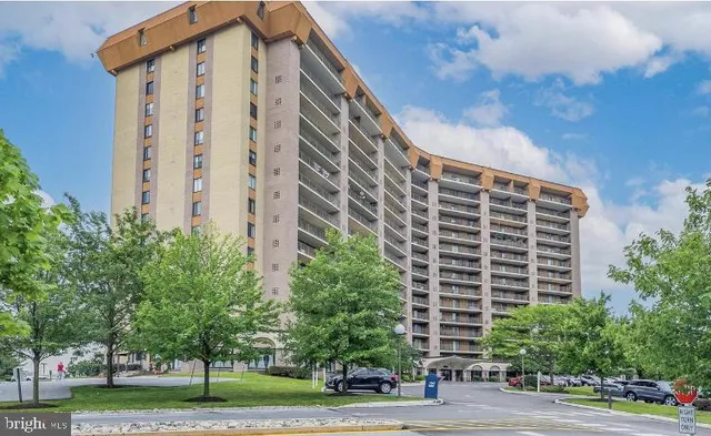 a front view of a building with a yard