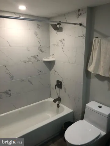 a view of closet with wooden floor